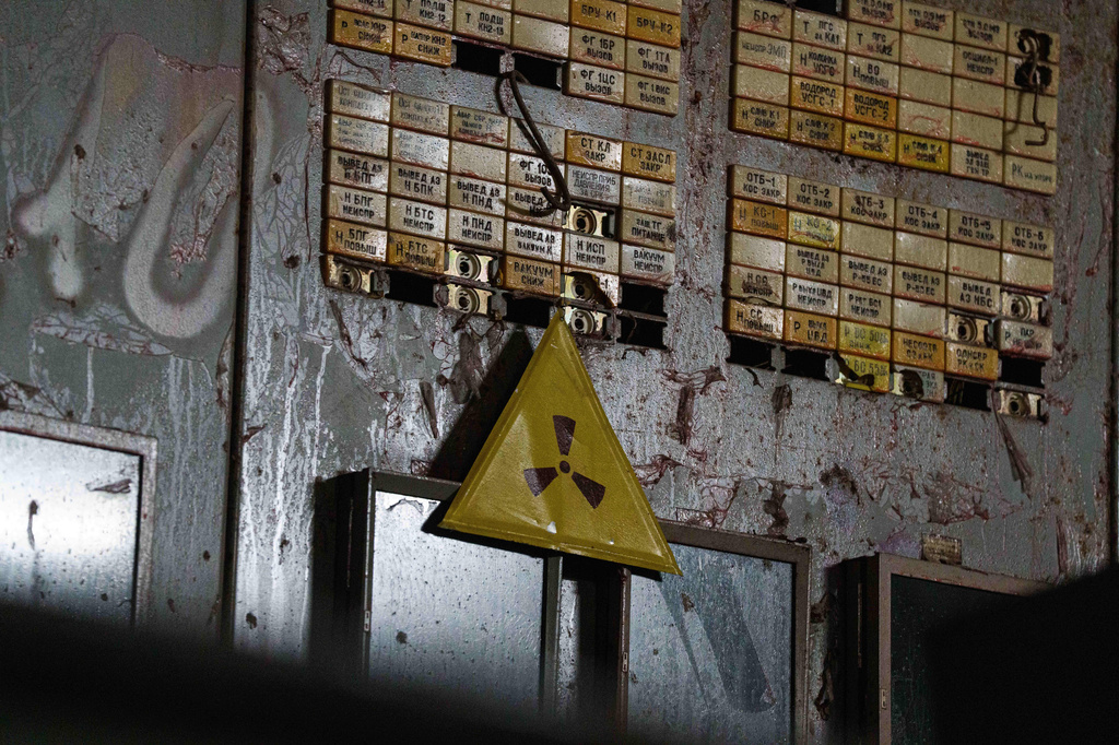 A radiation warning sign is seen on April 6, 2026, in the control room for Reactor No. 4 that exploded and burned in 1986 at the Chernobyl nuclear power plant in Ukraine. (AP Photo/Evgeniy Maloletka)