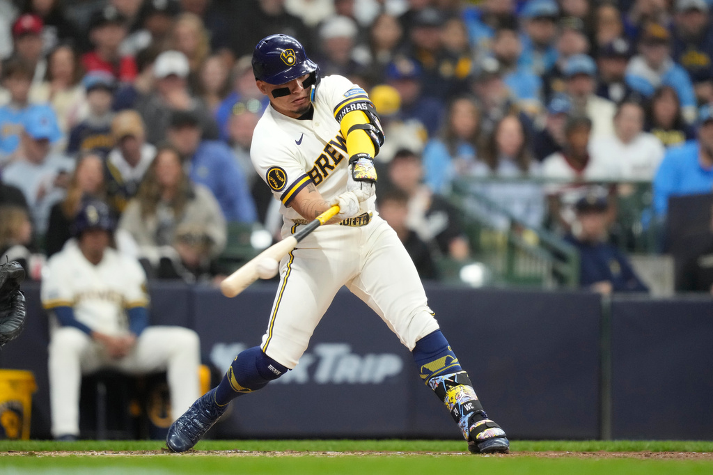 Milwaukee Brewers' William Contreras hits a three-run double during the second inning of an opening-day baseball game against the Chicago White Sox, Thursday, March 26, 2026, in Milwaukee. (AP Photo/Kayla Wolf)
