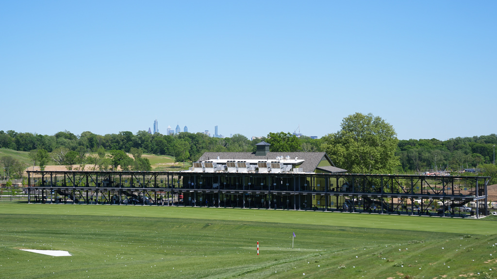 The Philadelphia skyline is seen above the driving range at the Cobbs Creek Golf Club in Philadelphia, Tuesday, May 12, 2026. (AP Photo/Matt Rourke)