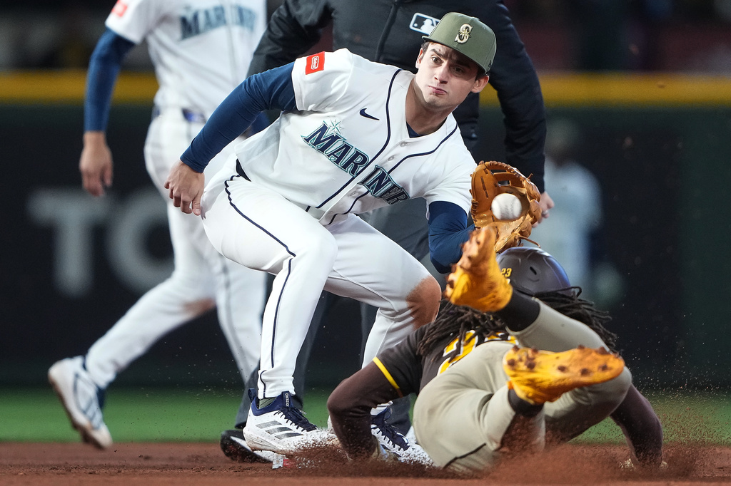 Seattle Mariners second baseman Cole Young catches San Diego Padres' Fernando Tatis Jr. stealing second base during the eighth inning of a baseball game, Saturday, May 16, 2026, in Seattle. (AP Photo/Lindsey Wasson)