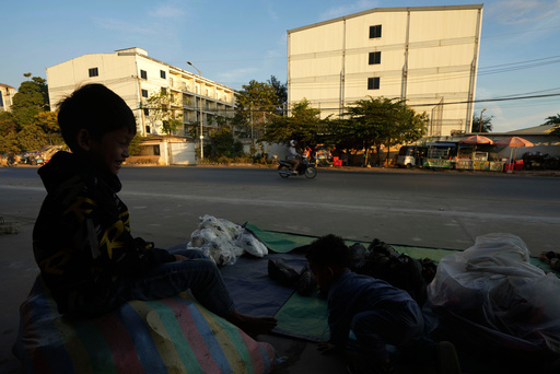 FILE - A boy plays near a building, where some people trafficked under false pretenses are being forced to work in online scams targeting people all over the world, in Phnom Penh, Cambodia, Feb. 9, 2025. (AP Photo/Heng Sinith, File) FILE - A boy plays near a building, where some people trafficked under false pretenses are being forced to work in online scams targeting people all over the world, in Phnom Penh, Cambodia, Feb. 9, 2025. (AP Photo/Heng Sinith, File)