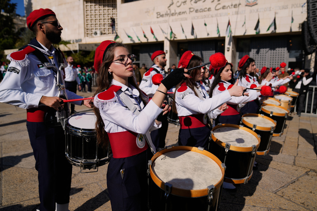 Palestinian scout bands parade at the Manger Square near the Church of the Nativity, traditionally believed to be the birthplace of Jesus, on Christmas Eve, in the West Bank city of Bethlehem, Wednesday, Dec. 24, 2025. (AP Photo/Nasser Nasser)