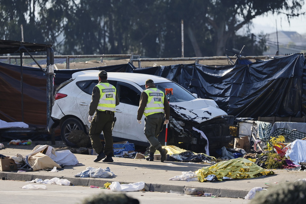 Police inspect a car after it struck a crowd at an open-air market in Vina del Mar, Chile, Sunday, July 12, 2026. (Sebastian Cisterna/ATON via AP)