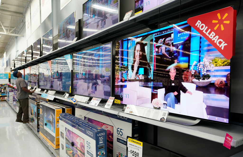 FILE - In this Nov. 9, 2018, file photo shoppers look at televisions at a Walmart Supercenter in Houston. (AP Photo/David J. Phillip, File)
