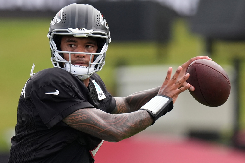Atlanta Falcons quarterback Tua Tagovailoa (1) works out during an NFL training camp, Friday, Aug. 7, 2026, in Flowery Branch, Ga. (AP Photo/Mike Stewart)