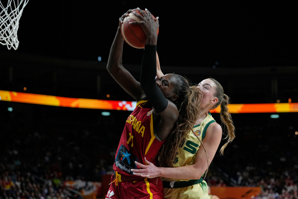 Spain's Awa Fam and Australia's Isabelle Bourne rebound during the Women's Basketball World Cup quarterfinal match between Australia and Spain in Berlin, Thursday, Sept. 10, 2026. (AP Photo/Ebrahim Noroozi)