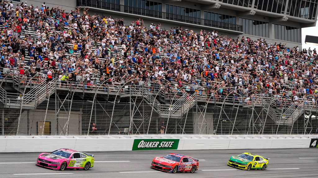 Ryan Blaney, Joey Logano, and Austin Cindric, from left, run during a NASCAR Cup Series auto race, Sunday, July 12, 2026, in Hampton, Ga. (AP Photo/Mike Stewart)