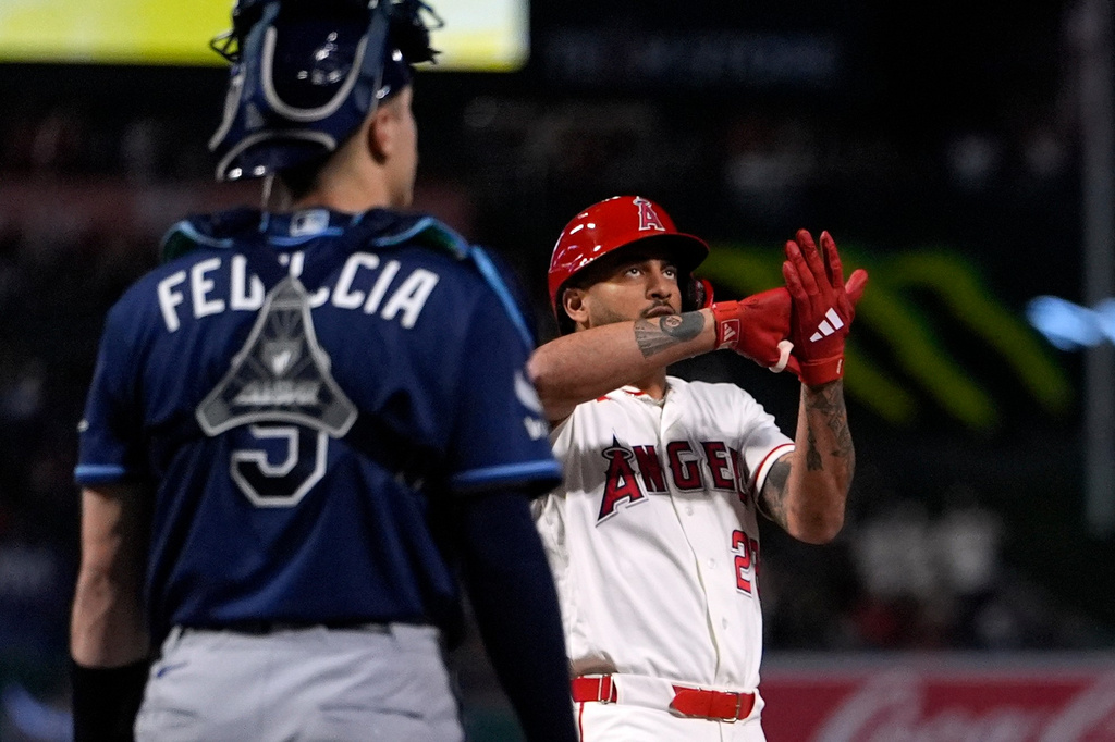 Los Angeles Angels' Jose Siri, right, gestures as he scores after hitting a two-run home run as Tampa Bay Rays catcher Hunter Feduccia looks on during the seventh inning of a baseball game Saturday, June 13, 2026, in Anaheim, Calif. (AP Photo/Mark J. Terrill)