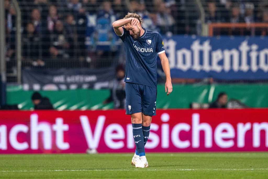 Bochum's Philipp Strompf reacts after scoring an own goal during the German soccer cup round of sixteen match beween VfL Bochum and VfB Stuttgart in Bochum, Germany, Wednesday, Dec. 3, 2025. (David Inderlied/dpa via AP)