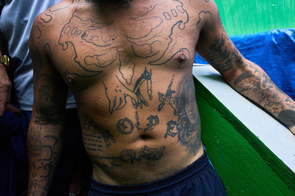 An inmate lines up for lunch at El Milagro Prison in Trujillo, Peru, Wednesday, May 20, 2026. (AP Photo/Rodrigo Abd)