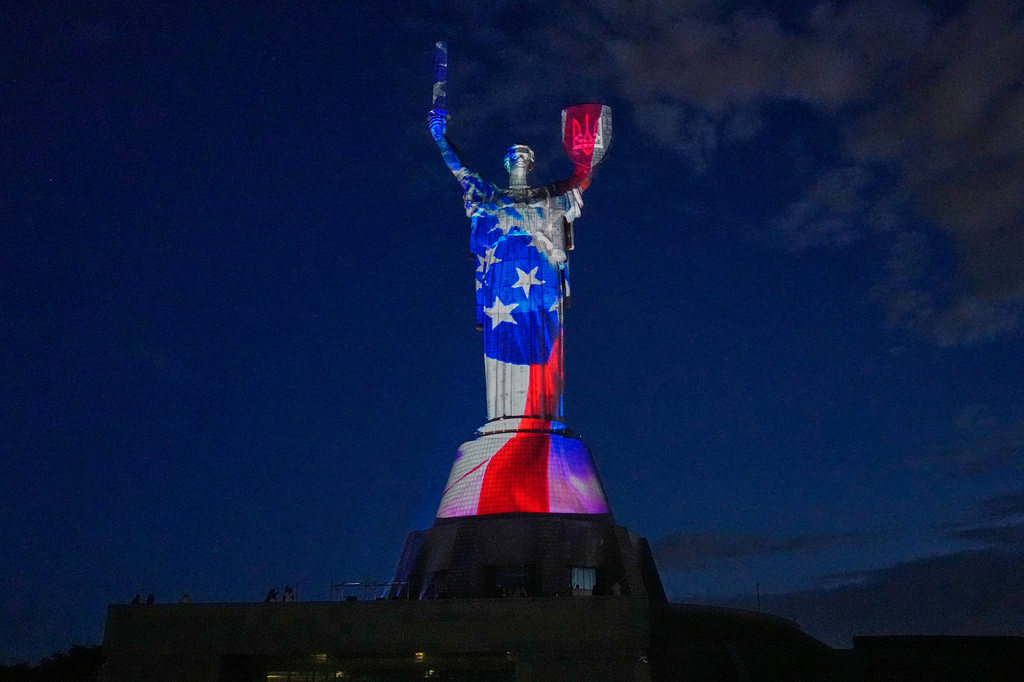 The Mother Ukraine Monument is illuminated in the colors of the U.S. flag in honor of the American 250th Independence Day, in Kyiv, Ukraine, Saturday, July 4, 2026. (AP Photo/Efrem Lukatsky)