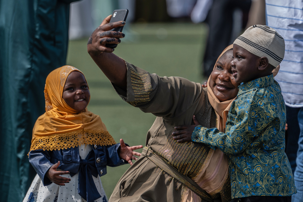 A woman takes a selfie with her son during the Eid al-Fitr prayers marking the end of the holy fasting month of Ramadan in Goma, Democratic Republic of Congo, Friday, March 20, 2026. (AP Photo/Moses Sawasawa)