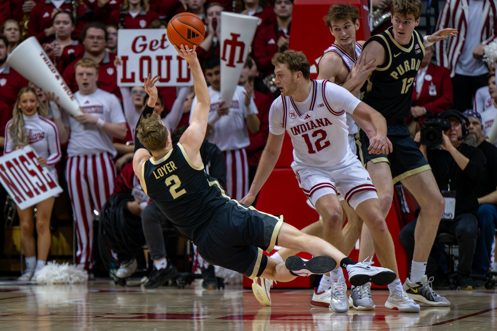 Purdue guard Fletcher Loyer (2) attempts a shot while falling to the court after slipping during the second half of an NCAA college basketball game against Indiana, Tuesday, Jan. 27, 2026, in Bloomington, Ind. (AP Photo/Doug McSchooler)