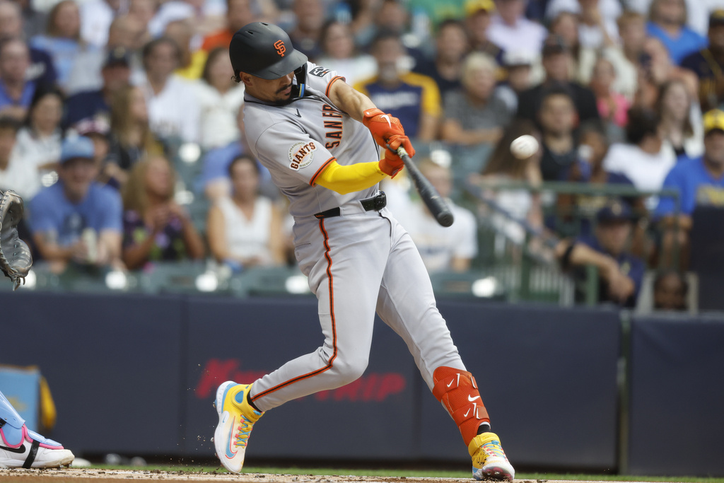 San Francisco Giants' Willy Adames hits a home run during the first inning of a baseball game against the Milwaukee Brewers, Friday, Aug. 22, 2025, in Milwaukee. (AP Photo/Jeffrey Phelps)