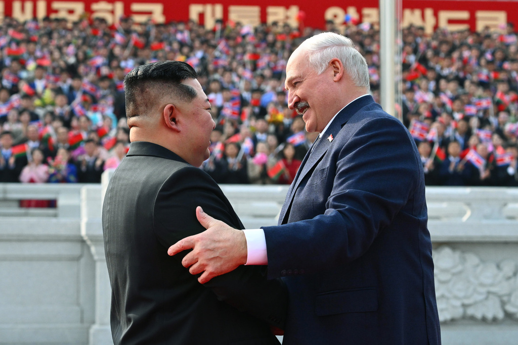 In this photo released by Belarus' Presidential Press Service, North Korea's leader Kim Jong Un, left, and Belarusian President Alexander Lukashenko greet each other during official meeting ceremony in Pyongyang, North Korea, Wednesday, March 25, 2026. (Belarus' Presidential Press Service via AP)