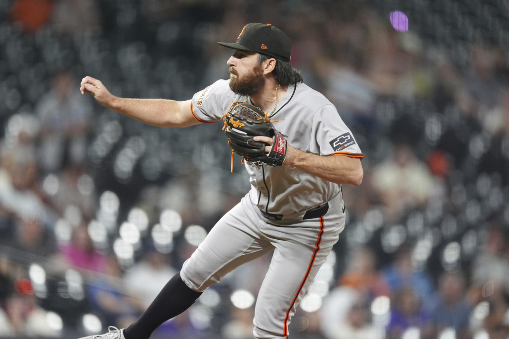 San Francisco Giants relief pitcher Ryan Walker works against the Colorado Rockies in the ninth inning of a baseball game Wednesday, Sept. 3, 2025, in Denver. (AP Photo/David Zalubowski)