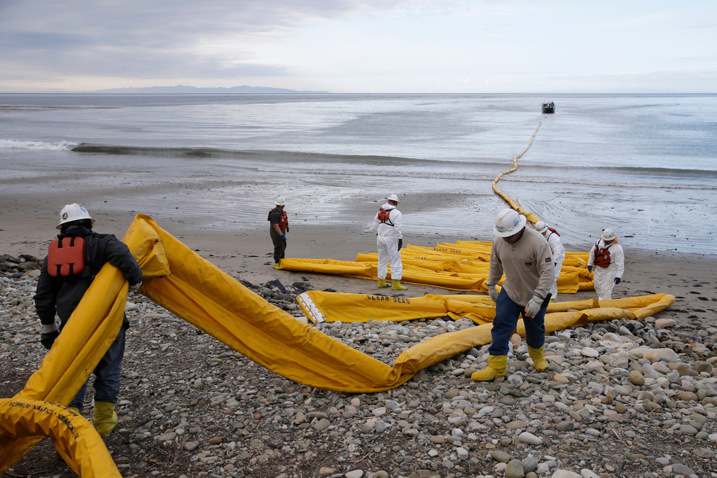FILE - Workers prepare an oil containment boom at Refugio State Beach, north of Goleta, Calif., May 21, 2015. (AP Photo/Jae C. Hong, File)