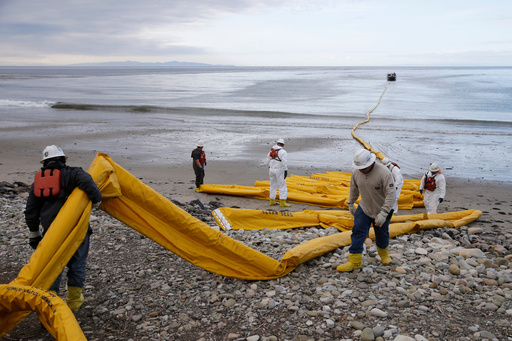 FILE - Workers prepare an oil containment boom at Refugio State Beach, north of Goleta, Calif., May 21, 2015. (AP Photo/Jae C. Hong, File) FILE - Workers prepare an oil containment boom at Refugio State Beach, north of Goleta, Calif., May 21, 2015. (AP Photo/Jae C. Hong, File)