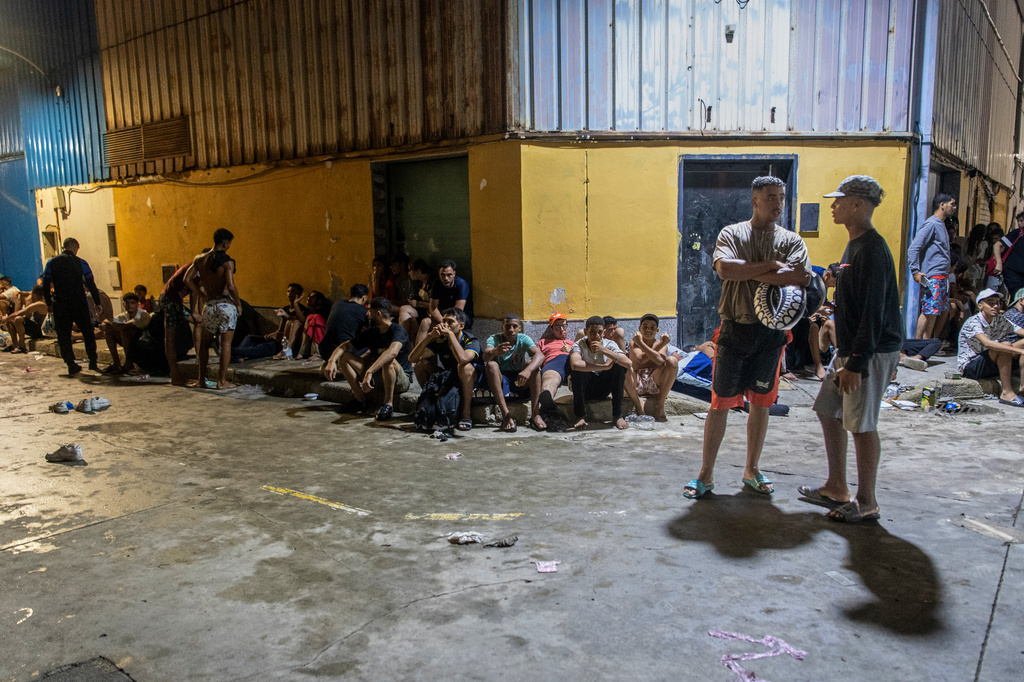 Migrants spend the night on the streets after crossing from Morocco into the Spanish enclave of Ceuta, Friday, July 31, 2026. (AP Photo/Antonio Sempere)