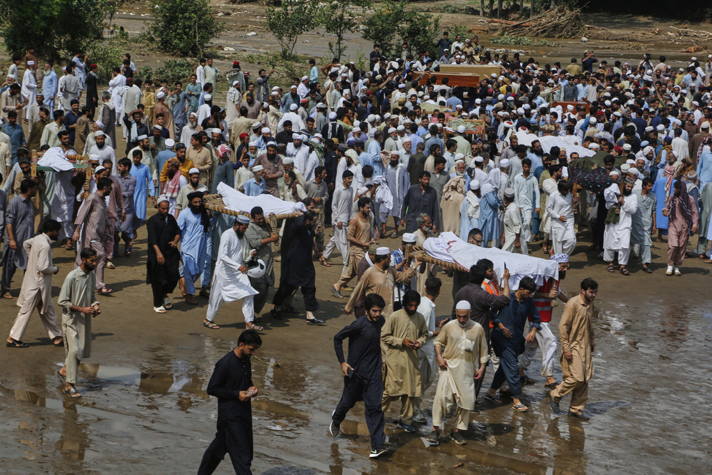 People carry bodies of victims of Friday's flash flooding, after funeral prayers at a village near Pir Baba, Buner district, in Pakistan's northwest, Saturday, Aug.16, 2025. (AP Photo/Muhammad Sajjad)