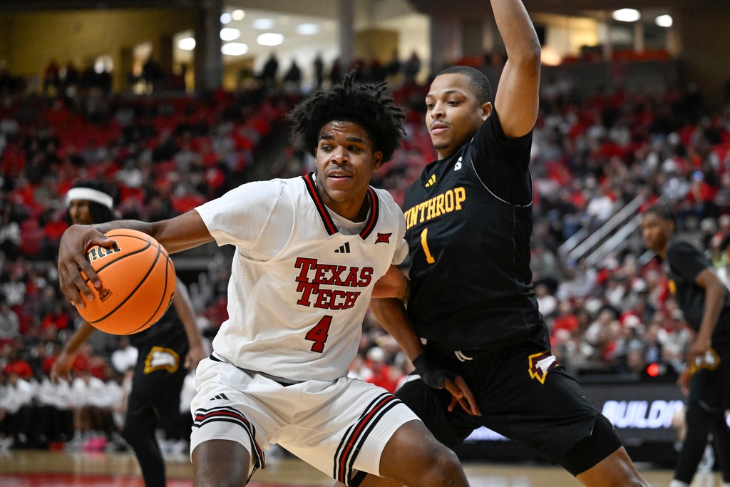 Texas Tech guard Christian Anderson (4) drives to the basket against Winthrop guard Isaiah Wilson (1) during the first half of an NCAA college basketball game Sunday, Dec. 28, 2025, in Lubbock, Texas. (AP Photo/Justin Rex)