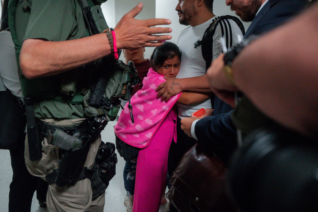 FILE - An asylum seeker from Ecuador hugs her father as he is detained by federal agents, July 31, 2025, in New York. (AP Photo/Olga Fedorova, file)