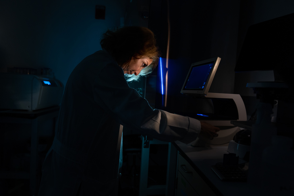 Dr. Mariana Kaplan, a rheumatologist and autoimmunity researcher, poses for a portrait working with a cell sample on a microscope in her lab at the National Institutes of Health, Monday, Aug. 25, 2025, in Bethesda, Md. Kaplan is an NIH Distinguished Investigator who leads research on systemic autoimmune diseases at the National Institute of Arthritis and Musculoskeletal and Skin Diseases. Kaplan's path to a career trying to unravel autoimmune diseases began while she was a doctor-in-training and helped care for young women severely ill with lupus, including one who died, at a time when there were fewer treatments. "No matter what I did, the diseases just progressed. I felt so impotent and frustrated about it, and so sad for them. The immune system in general fascinated me but this concept of autoimmunity and losing tolerance to yourself – what was causing this?" (AP Photo/David Goldman)