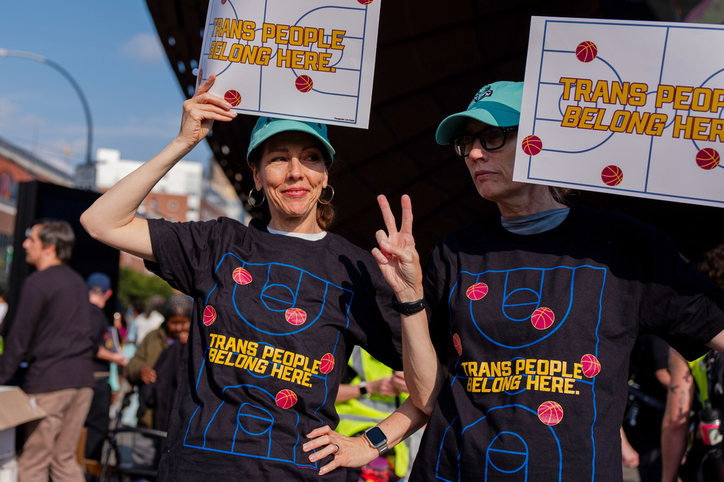 FILE - Demonstrators rally in support of transgender athletes in women's sports outside of Barclay's Center before the WNBA basketball game between the Indiana Fever and the New York Liberty, Aug. 22, 2026, in New York. (AP Photo/Angelina Katsanis, File)