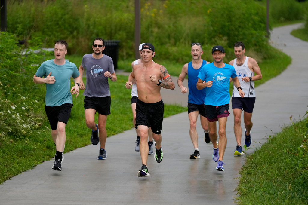Members of the Raccoon River Running Club train on a trail at Raccoon River Park, Sunday, Aug. 9, 2026, in West Des Moines, Iowa. (AP Photo/Charlie Neibergall)