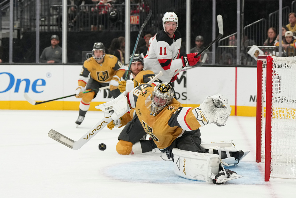 Vegas Golden Knights goaltender Carter Hart (79) stops a shot from the New Jersey Devils during the first period of an NHL hockey game Wednesday, Dec. 17, 2025, in Las Vegas. (AP Photo/Candice Ward)