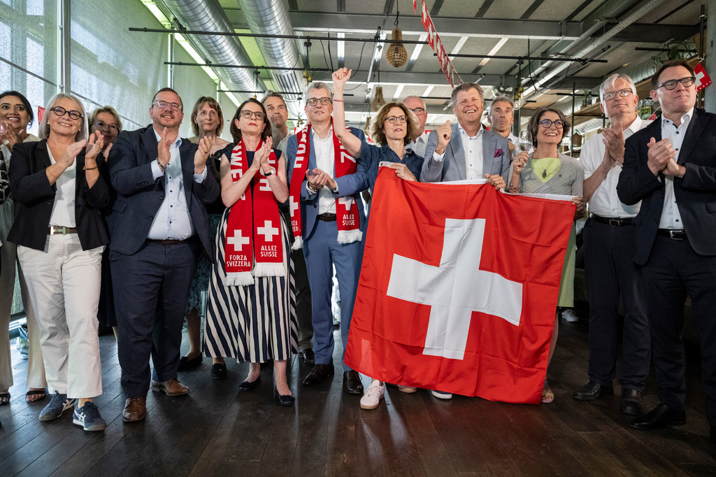 Members of the Federal Parliament and other representatives of civic organizations, celebrate during a get together of a cross-party alliance against the SVP's popular initiative "No 10-Million Switzerland" which the people and the cantons voted on this election Sunday, June 14, 2026, in Bern, Switzerland. (Alessandro della Valle/Keystone via AP)