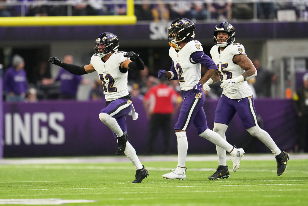 Baltimore Ravens safety Alohi Gilman (12) celebrates a defensive stop on fourth down in the second half of an NFL football game against the Minnesota Vikings, Sunday, Nov. 9, 2025, in Minneapolis. (AP Photo/Abbie Parr)