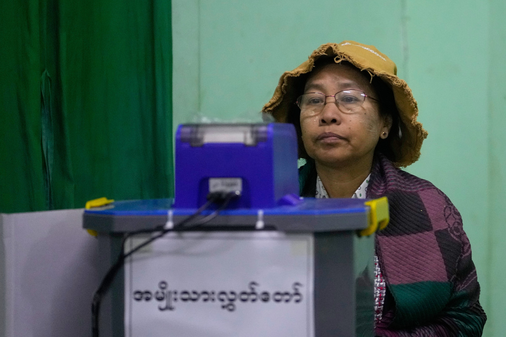 A voter casts a ballot at a polling station in Naypyitaw, Myanmar, Sunday, Dec. 28, 2025. (AP Photo/Aung Shine Oo)