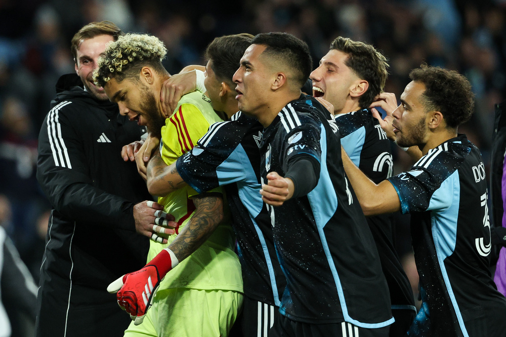 Minnesota United players celebrate their win in a penalty shootout in Game 1 of the first round of MLS soccer's Western Conference playoffs against Seattle Sounders Monday, Oct. 27, 2025, in St. Paul, Minn. (AP Photo/Matt Krohn)