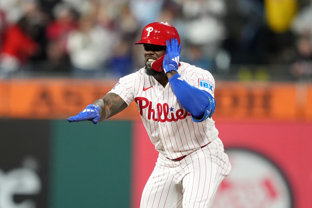 Philadelphia Phillies' Adolis García reacts after hitting a two-run double against San Francisco Giants pitcher Tyler Mahle during the sixth inning of a baseball game Tuesday, April 28, 2026, in Philadelphia. (AP Photo/Matt Slocum)