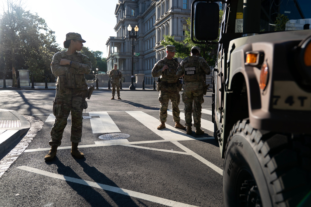 Members of the National Guard stands guard the streets near the White House complex Saturday, June 13, 2026, in Washington. (AP Photo/Jose Luis Magana)