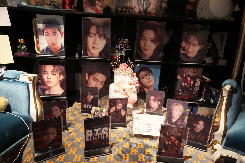 Photos of K-pop band BTS members are displayed at a cafe in Seoul, South Korea, Tuesday, March 17, 2026. (AP Photo/Lee Jin-man)