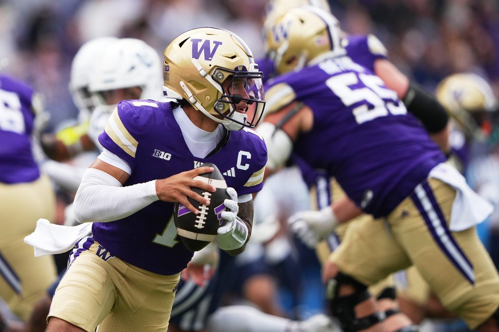 Washington quarterback Demond Williams Jr. runs the ball against Utah State during the second half of an NCAA college football game Saturday, Sept. 12, 2026, in Seattle. (AP Photo/Lindsey Wasson)