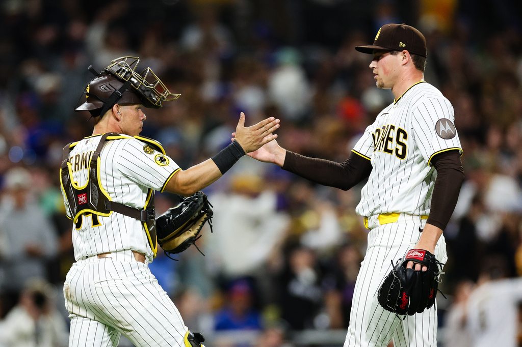 San Diego Padres' Mason Miller, right, celebrates with Freddy Fermin after the team defeated the New York Mets in a baseball game Saturday, June 6, 2026, in San Diego. (AP Photo/Derrick Tuskan)