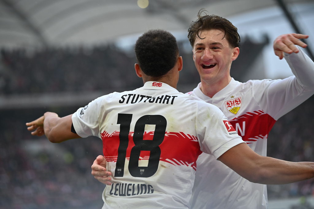 Stuttgart's Angelo Stiller, right, Jamie Leweling celebrates with Jamie Leweling after scoring the opening goal during the German Bundesliga soccer match between VfB Stuttgart and Hamburger SV, in Stuttgart, Germany, Sunday, April 12, 2026. (Katharina Kausche/dpa via AP)