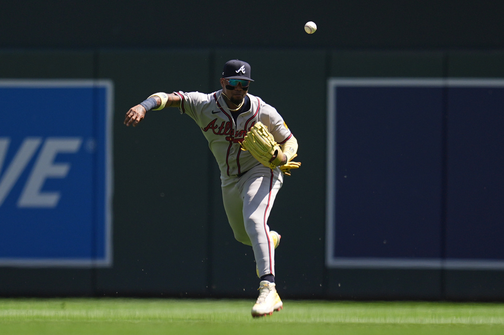 Atlanta Braves right fielder Ronald Acuña Jr. loses control of the ball while throwing after fielding a single hit by Minnesota Twins' Luke Keaschall during the fifth inning of a baseball game, Wednesday, Aug. 19, 2026, in Minneapolis. (AP Photo/Abbie Parr)