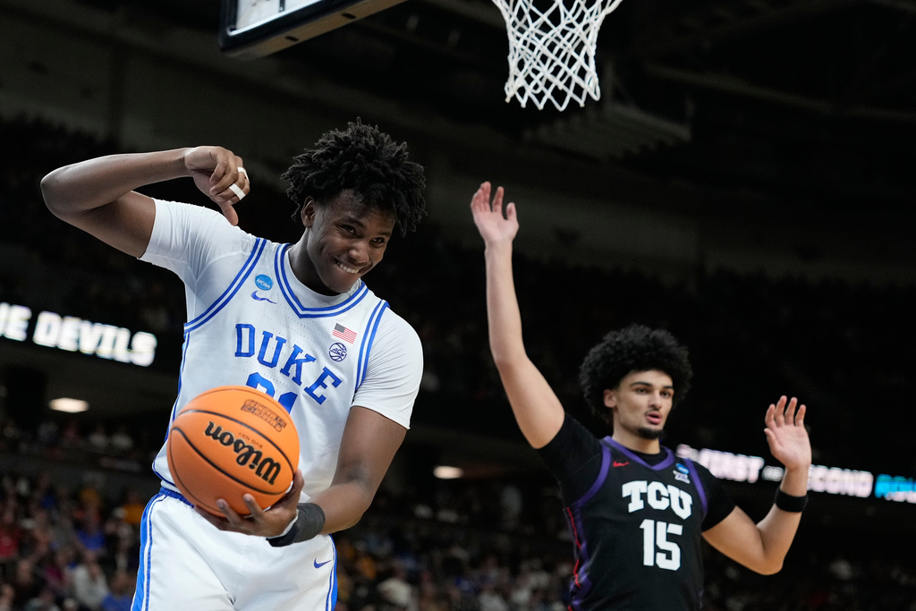 Duke center Patrick Ngongba (21) reacts after he releases the ball during the first half in the second round of the NCAA college basketball tournament against TCU, Saturday, March 21, 2026, in Greenville, S.C. (AP Photo/Brynn Anderson)