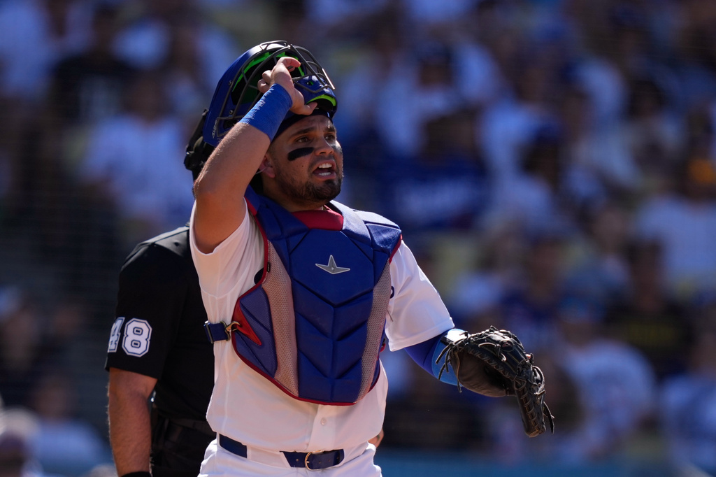 Los Angeles Dodgers catcher Eliezer Alfonzo watches as San Diego Padres' Manny Machado flies out during the first inning of a baseball game, Sunday, July 5, 2026, in Los Angeles. (AP Photo/Mark J. Terrill)