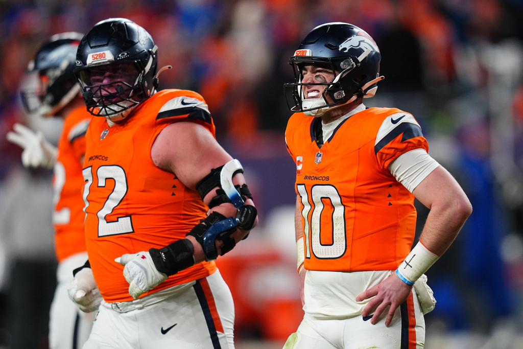 Denver Broncos quarterback Bo Nix (10) reacts as he returns to the sidelines after an injury during overtime of an NFL divisional round playoff football game against the Buffalo Bills, Saturday, Jan. 17, 2026, in Denver. (AP Photo/Jack Dempsey)