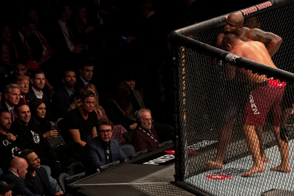 FILE - President Donald Trump watches Derrick Lewis fight Blagoy Ivanov, right, at UFC 244 at Madison Square Garden, Nov. 2, 2019, in New York. (AP Photo/ Evan Vucci, File)