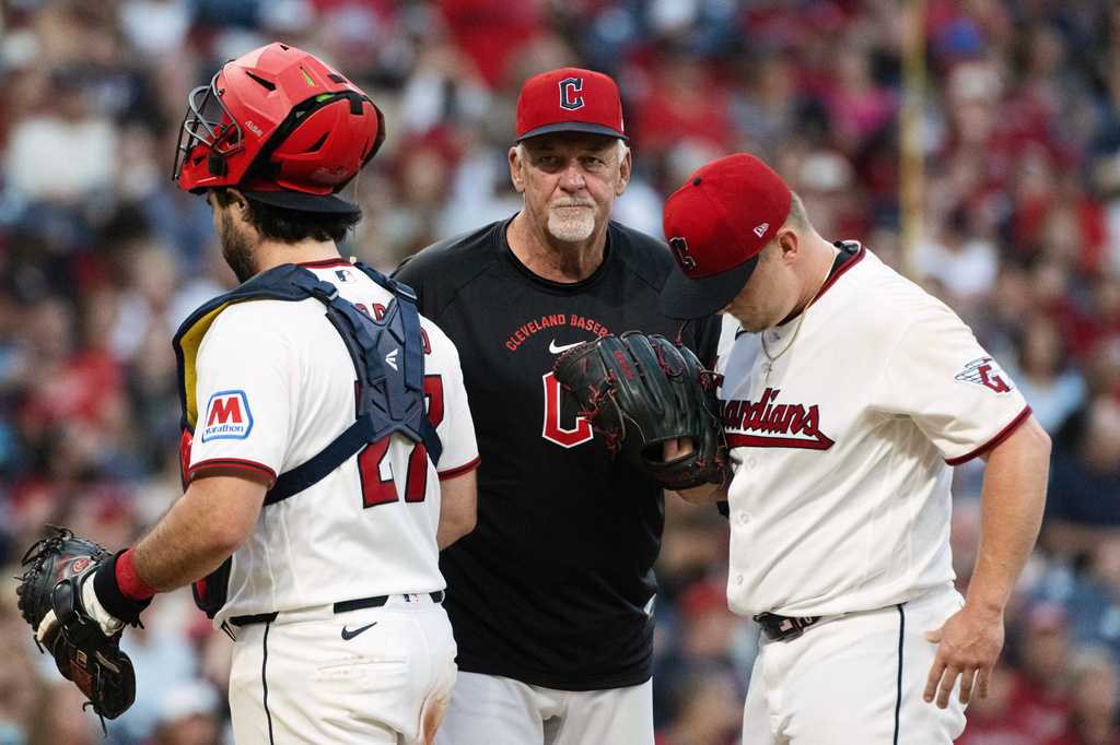 Cleveland Guardians pitching coach Carl Willis, center, has a mound meeting with starting pitcher Parker Messick, right, and catcher Austin Hedges, left, during the sixth inning of a baseball game against the Detroit Tigers, Saturday, Sept. 5, 2026, in Cleveland. (AP Photo/Phil Long)