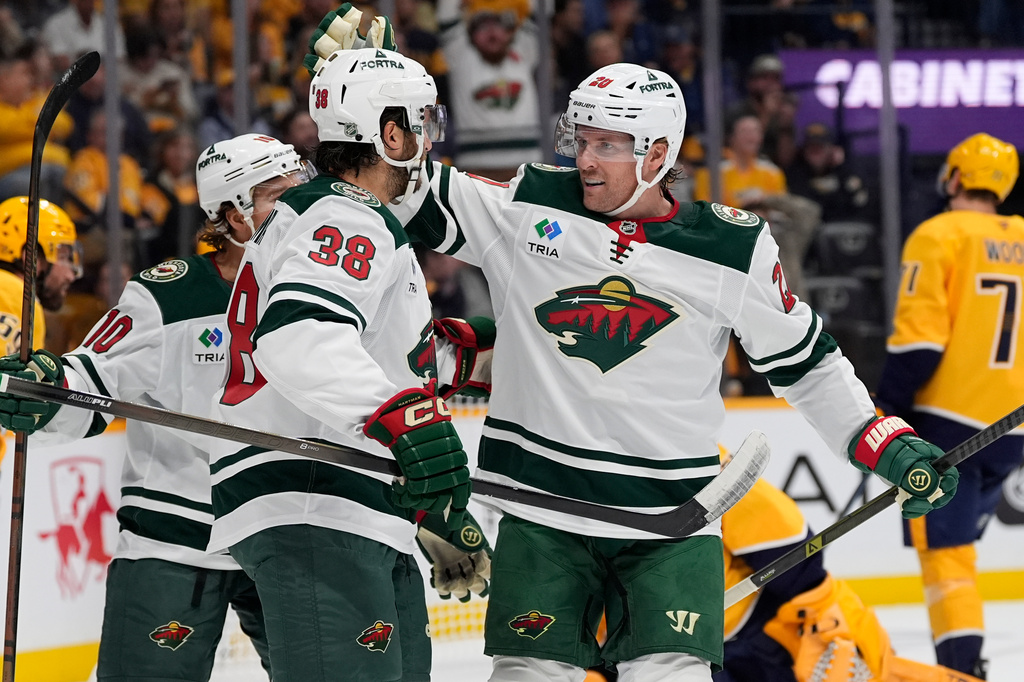 Minnesota Wild left wing Blake Coleman (20) celebrates his goal with right wing Ryan Hartman (38) during the first period of an NHL hockey game Thursday, Oct. 1, 2026, in Nashville, Tenn. (AP Photo/George Walker IV)