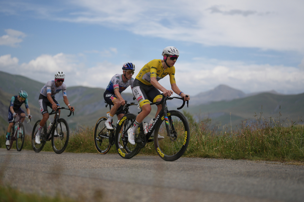Slovenia's Tadej Pogacar climbs the Sarenne pass ahead of Belgium's Remco Evenepoel, center, and Mexico's Isaac Del Toro, left, during the twentieth stage of the Tour de France cycling race with start in Le Bourg d'Oisans and finish in Alpe d'huez, France, Saturday, July 25, 2026. (AP Photo/Thibault Camus)