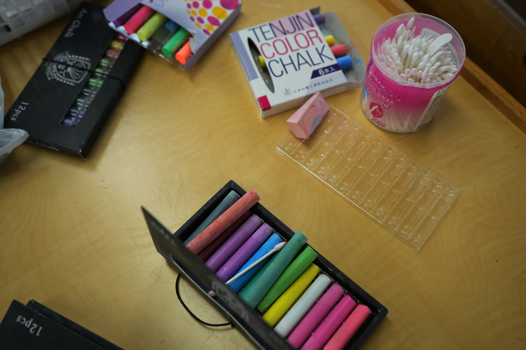 Color chalks are placed on a desk at a classroom for the art club at Kumagaya Girls High School in Kumagaya, northwest of Tokyo, Tuesday, July 21, 2026. (AP Photo/Hiro Komae)