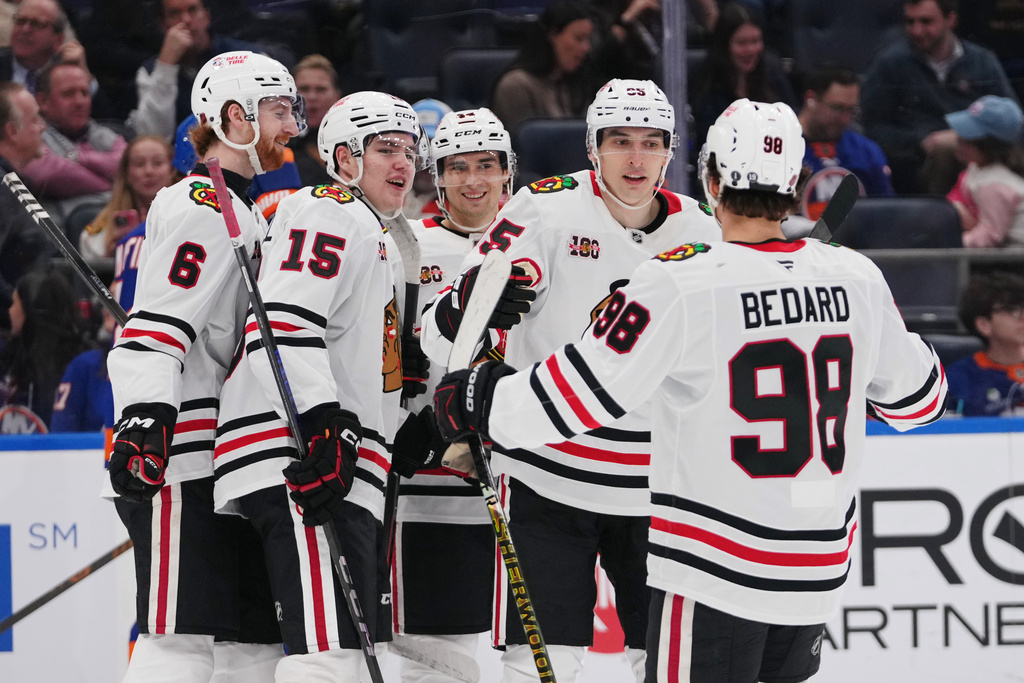 Chicago Blackhawks' Ilya Mikheyev (95) celebrates with teammates Sam Rinzel (6), Anton Frondell (15), Connor Bedard (98) and Wyatt Kaiser after scoring a goal during the first period of an NHL hockey game Tuesday, March 24, 2026, in Elmont, N.Y. (AP Photo/Frank Franklin II)